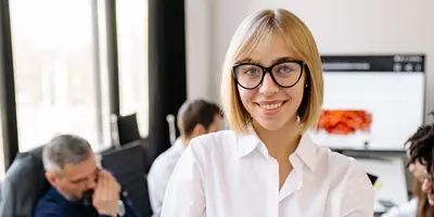 Ein Portrait einer Frau in einem weißen Langarmhemd