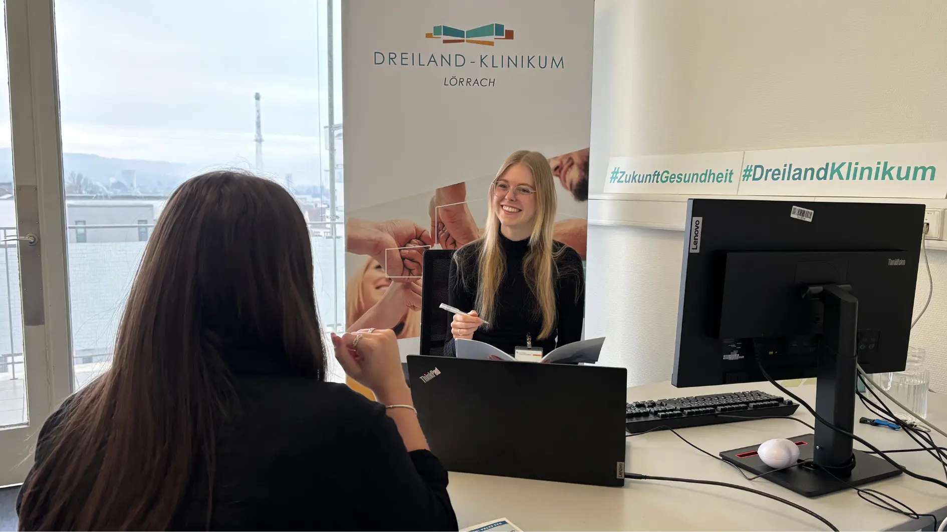 Eine Frau im Austausch mit einer Mitarbeiterin